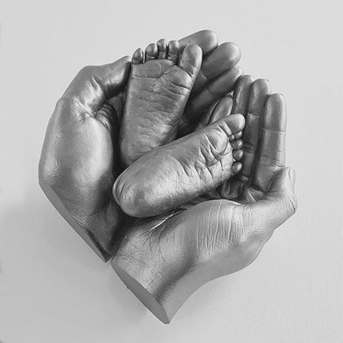 Bowl-of-Love Memory Castings Love Sculpture featuring two baby feet in a vessel created by their parent's hands.